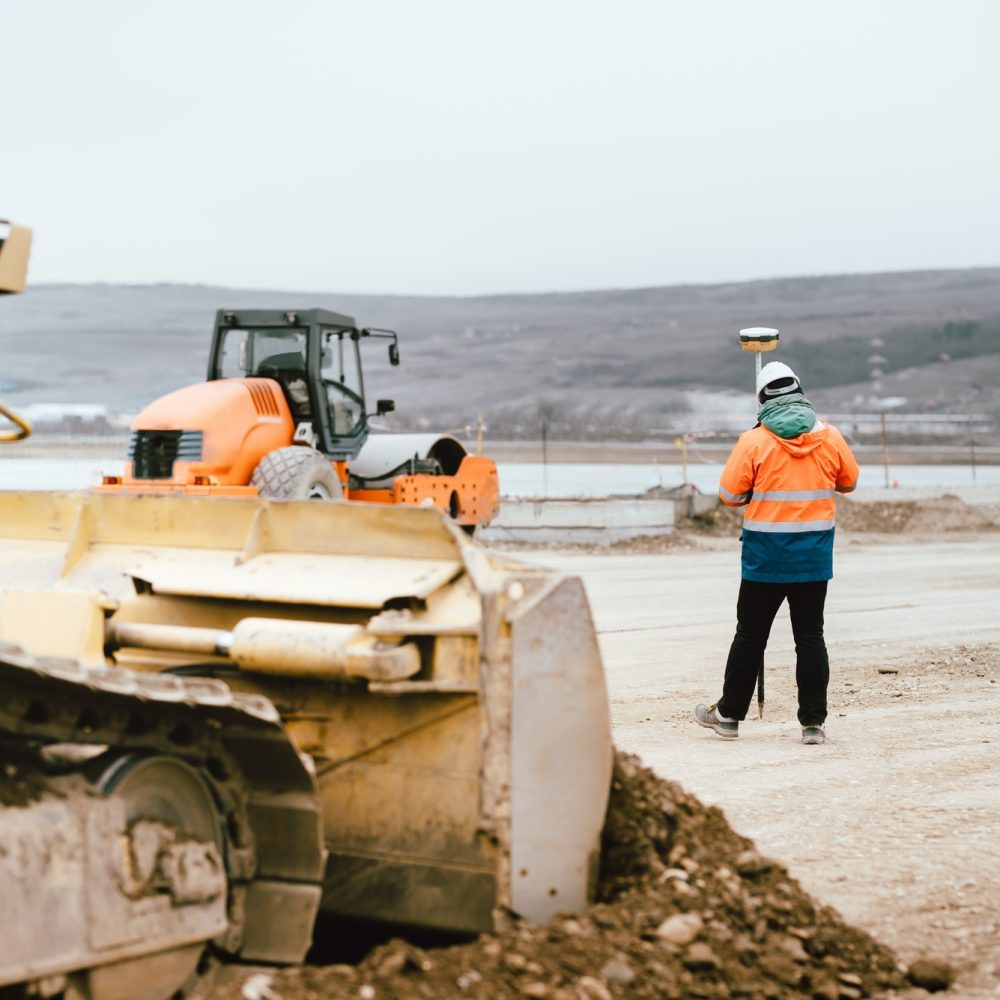 surveyor-engineer-with-gps-system-outdoors-at-highway-construction-site.jpg